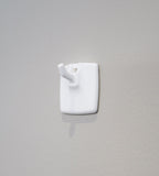 Self-adhesive hook for wall calendar – sticks to smooth surfaces without tools