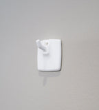 Self-adhesive hook for wall calendar – sticks to smooth surfaces without tools
